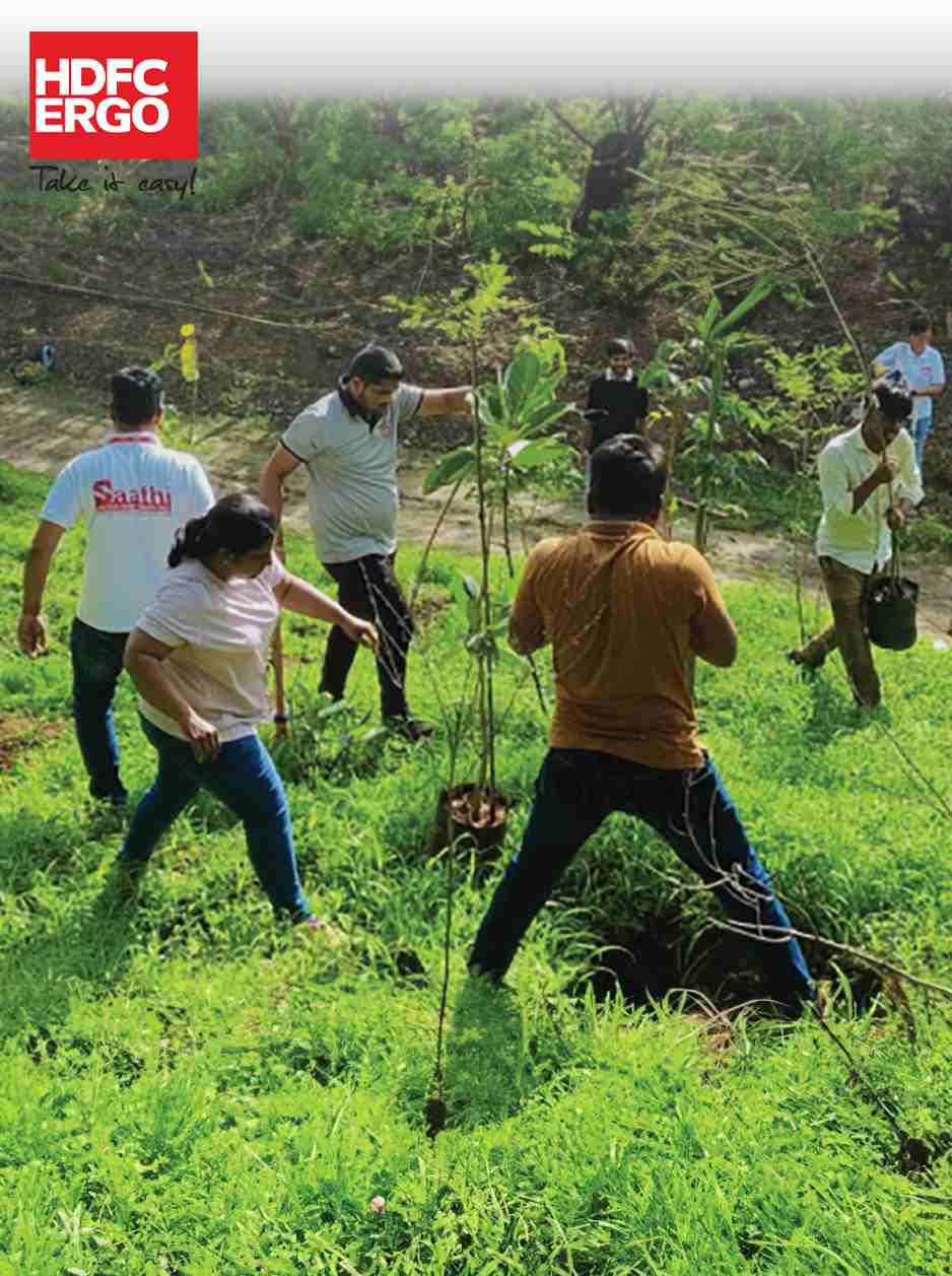 Young volunteers planting saplings to restore greenery in India